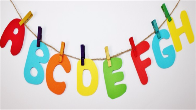 Coloured cut out letters of the alphabet hung with pegs to a piece of string